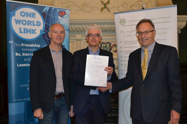 Clive Harridge (Secretary-General, Commonwealth Association of Planners and Warwickshire resident) presents the Award certificate to John Archer and Philip Clarke from One World Link at the Town Hall, Leamington Spa.